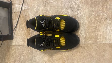 Black and yellow Jordan 4s