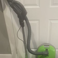 The Kenmore 116 is a lime green canister vacuum with cord rewind and HEPA filters. It is a bagged vacuum with included accessories and a corded power 