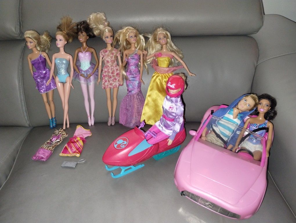 8 Barbies, Ken, Barbie Corvette, Snowmobile, Assorted Accessories And Dresses