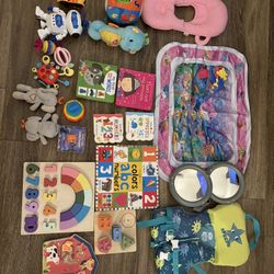 Random Assortment Of Baby Toys And Books 