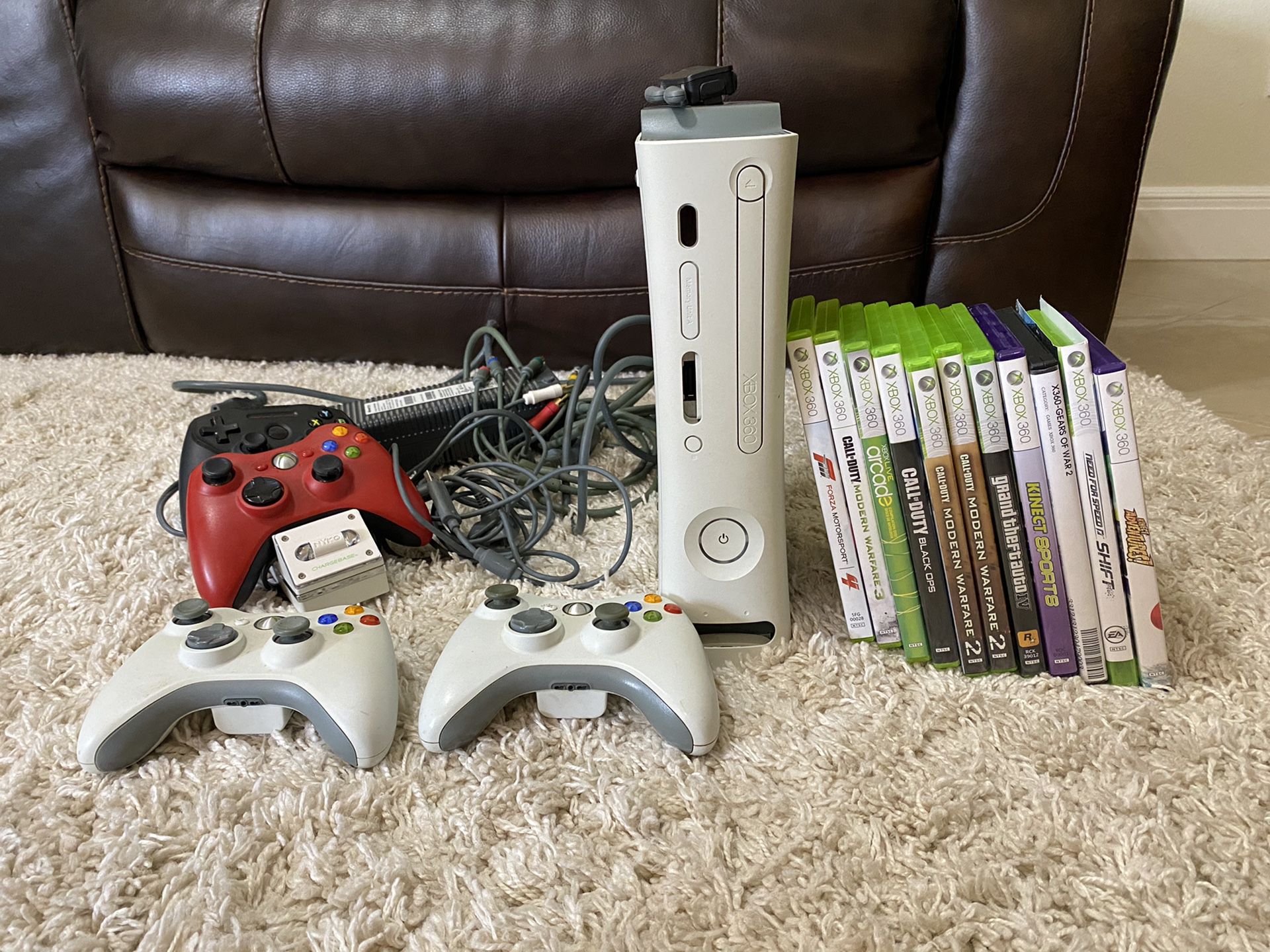 XBOX 360 with games, wireless network adaptor, controllers, and chargers