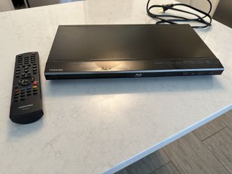 Toshiba Blu-Ray disc player with HDMI cord and remote.
