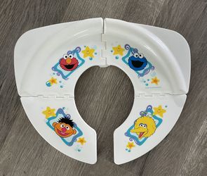 Collapsible Sesame Street toilet seat cover. 