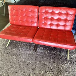Two iconic Barcelona red leather chairs