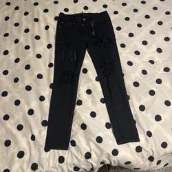Black amiri ripped jeans