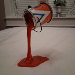 VINTAGE Pop Art 1980s pouring paint can piggy bank/sculpture. Metal paint can with a quarter-sized coin slot, defying gravity...asking $100.00 