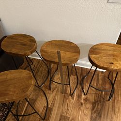 wooden, saddle seat barstool, with metal legs. 29 1/4 inches high.