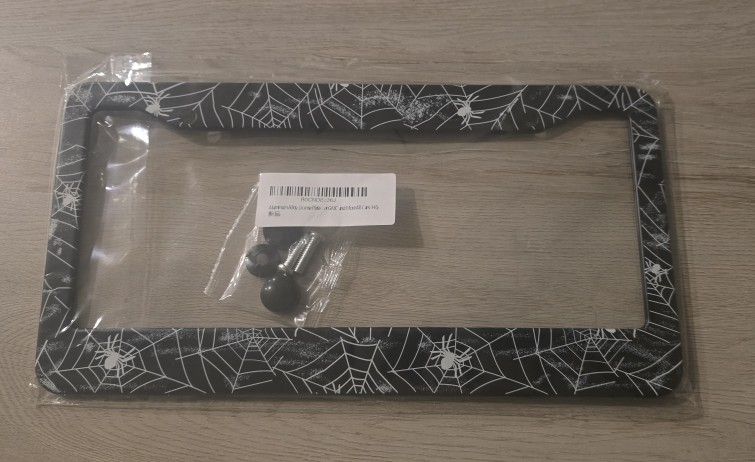Spider web aluminum license plate frame