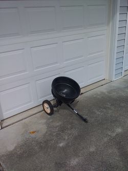 Pull behind mower spreader