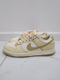 Size 11 New Nike Dunk Low in the Muslin/Team Gold colorway.