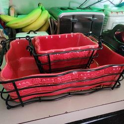 Pair of red stoneware Casserol dishes with metal and Wicker baskets