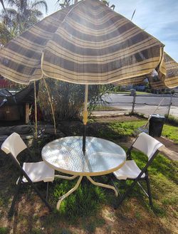 Glass Table, Umbrella, And Chairs