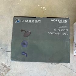Glacier bay new bronze shower head and  facet . .