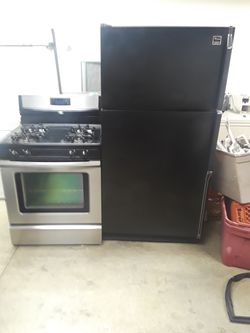 Whirlpool stainless steel stove and Whirlpool black refrigerator