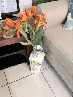 Ceramic base with plastic flowers