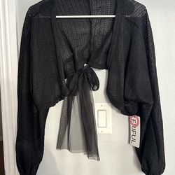 cropped, open-front silhouette often referred to as a "tie-back cardigan" or "bolero shrug".