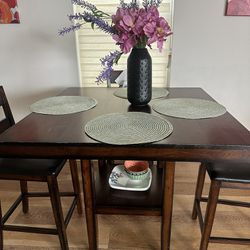 Transform your dining space with this elegant wooden square table and matching chairs!