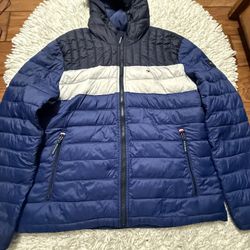 Men's Tommy Hilfiger Lightweight Puffer Jacket in a blue, white, and black color-block design  Xl on tag  In very good condition