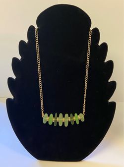 Gold chain with variety of green colored stones