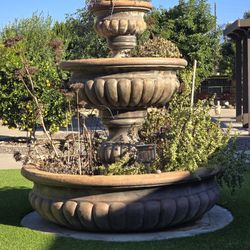 Multi tiered outdoor stone fountain
