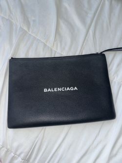 Balenciaga Pochette in black.
