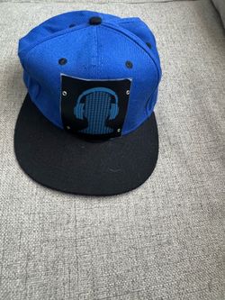 Cybwear snapback cap features a blue crown, a black brim, and a sound-activated LED panel