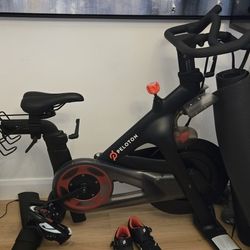 Peloton Bike + 2 Pairs of Shoes (W&M), Floor Mat & Seat Cushion — No Weights