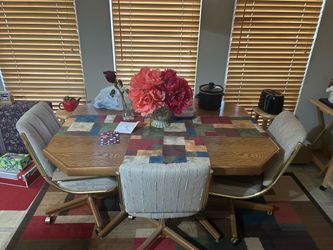 Slightly love dining table with 4 chairs with rollers