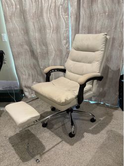 Massaging desk chair with footrest