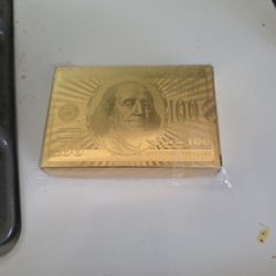 novelty gold-plated playing cards featuring a $100 bill design
