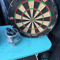 Unicorn Eclipse HD2 bristle dartboard with various darts and accessories