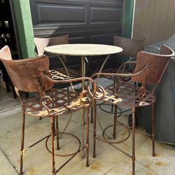 vintage wrought iron patio bar stools and a matching table