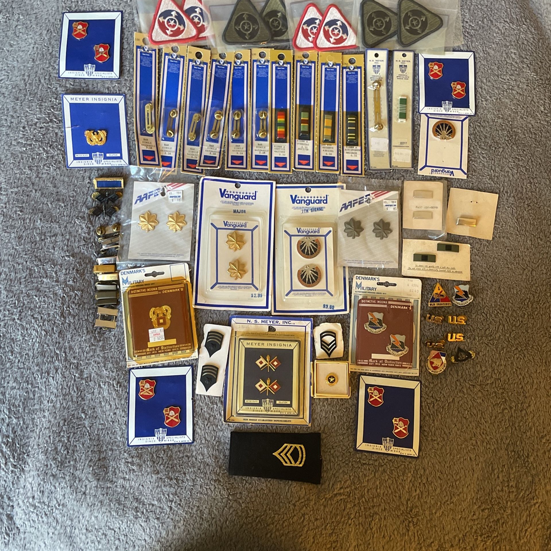 Collection of U.S. military insignia, patches, and rank devices