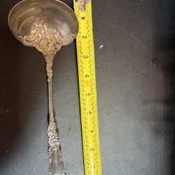 Antique silver ladle with elegant engraving, made in Art Nouveau style.