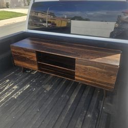 Wood tv Stand on the top has a little damage see the last picture