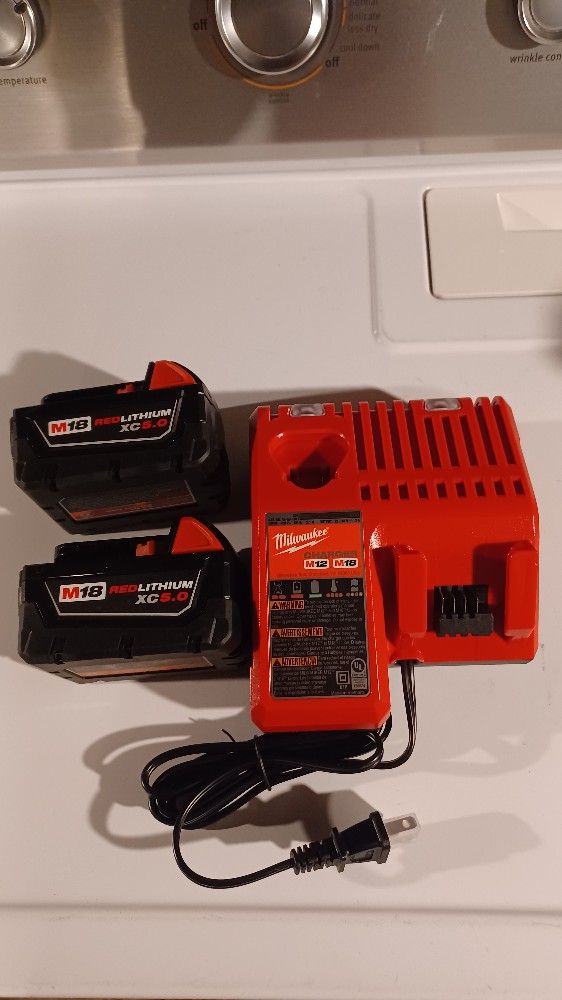 Milwaukee two XC5.0 batteries with charger