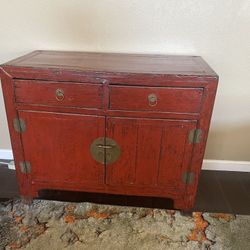 Antique Chinese Wooden Cabinet with a striking red lacquer finish and brass hardware.