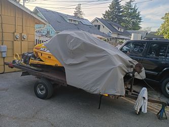 Flat bed trailer with 2 snow mobiles