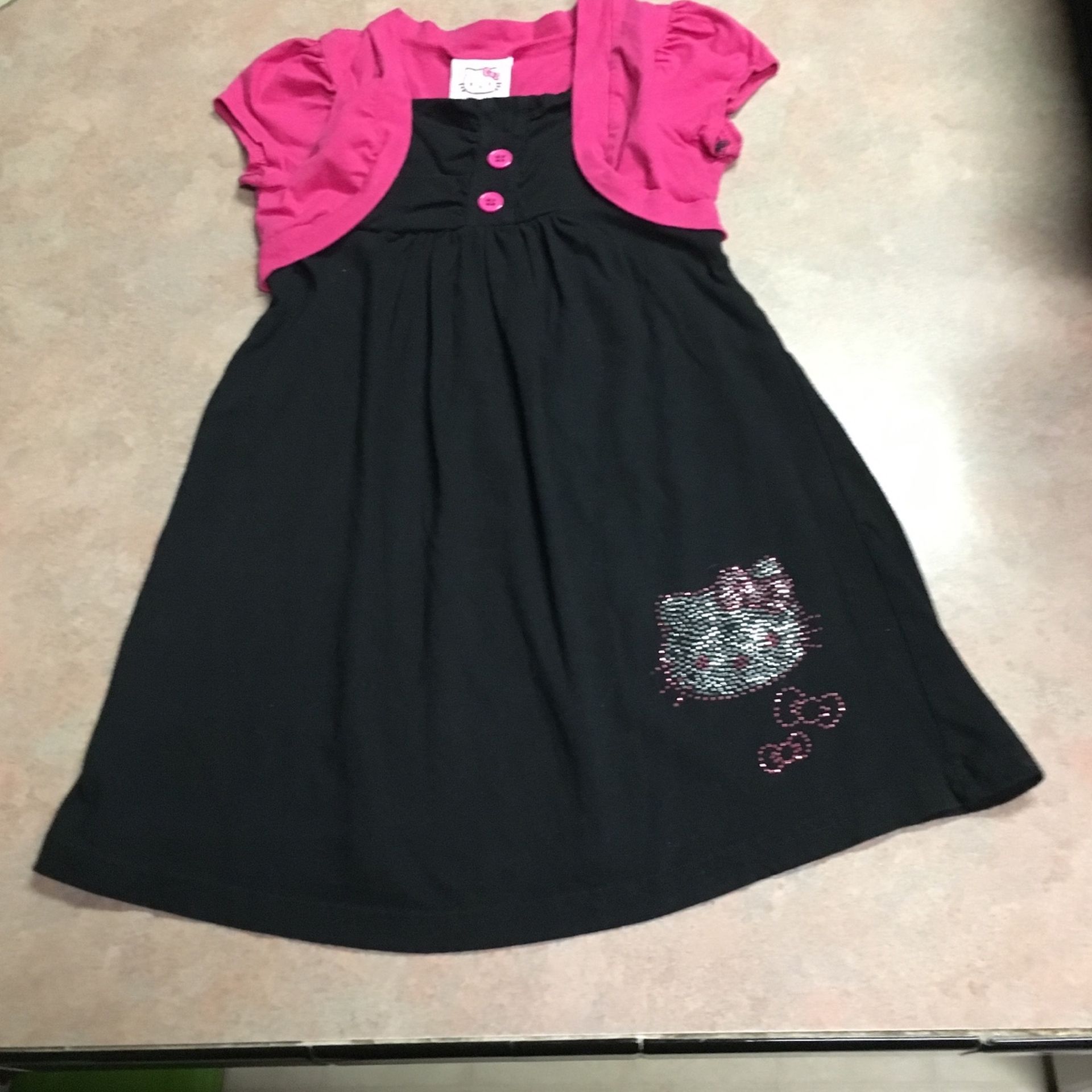 This is a cute hello Kitty dress for a little girl. It is a size 6 (T-1)