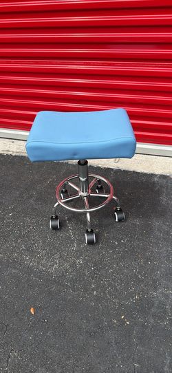 Blue rolling salon chair