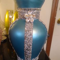 TURQUOISE VASE COVERED IN GEMS.