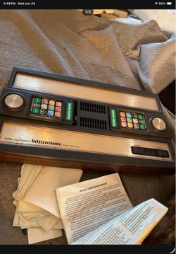original Intellivision video game system with 23 games , case , original brochures