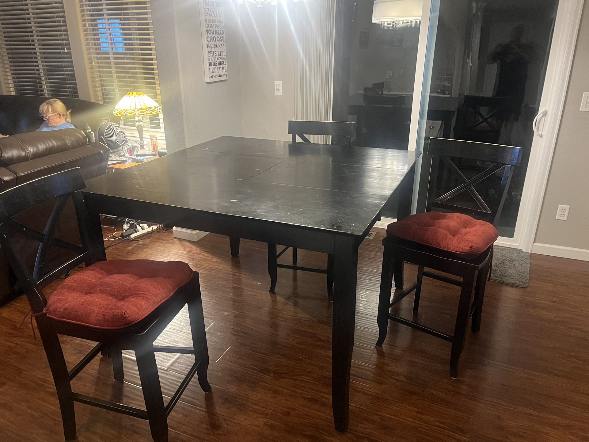 Black high top kitchen table with seven chairs