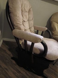 Beige Upholstered glider with dark wood frame