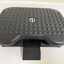 Under-the desk ergonomic footrest with adjustable height and angle and textured massage surface.