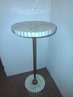 Small drink table with abalone like design, solid