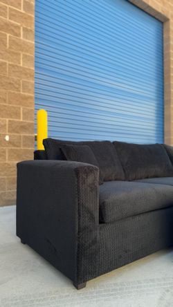 All black sectional couch with ottoman
