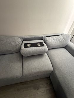 Grey L pull out couch with cup holders