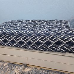 White twin bed with trundle and storage