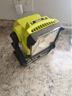 Two hybrid Ryobi floodlights with adjustable stand